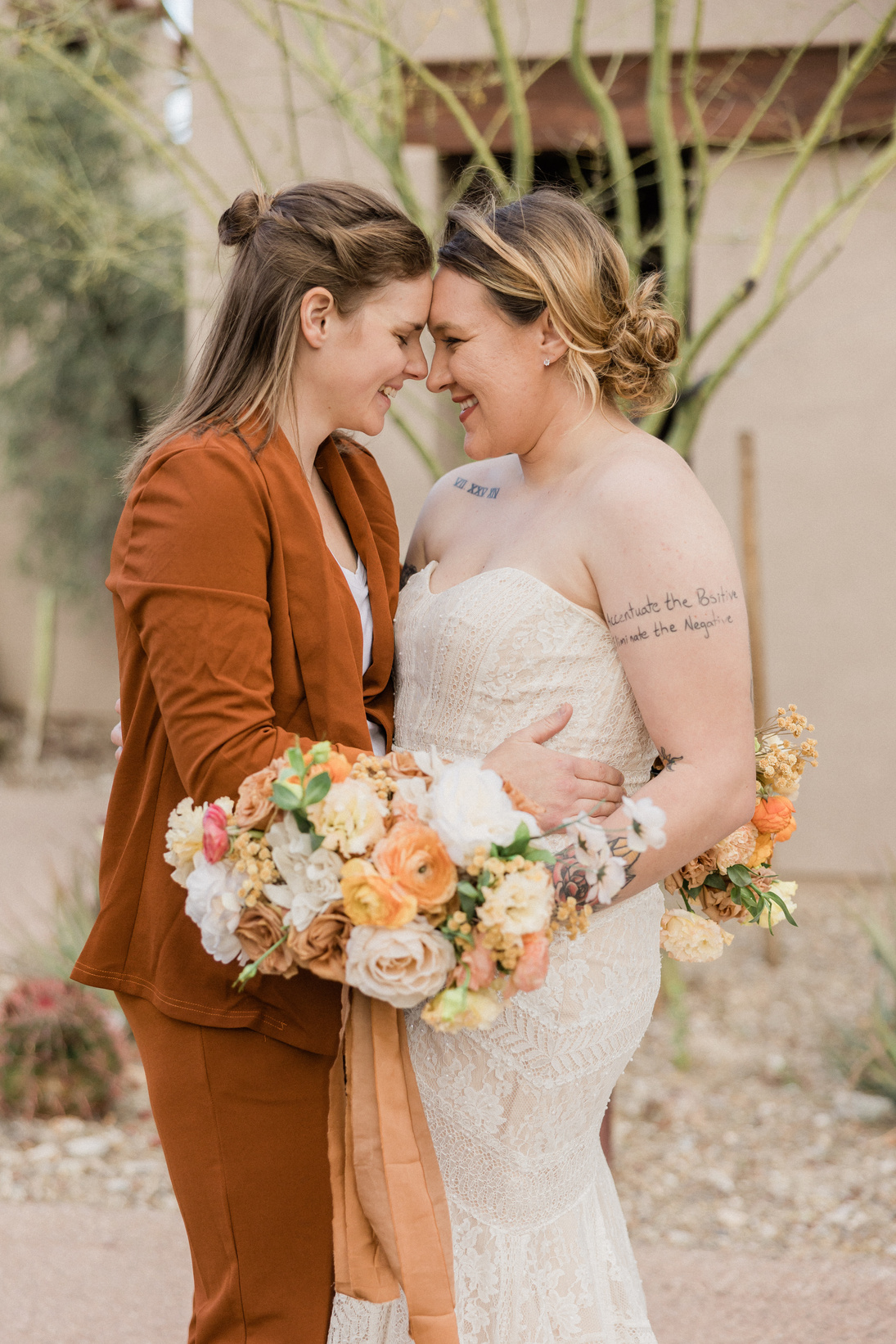 Newlywed Couple with Bridal Bouquets Posing Outdoors